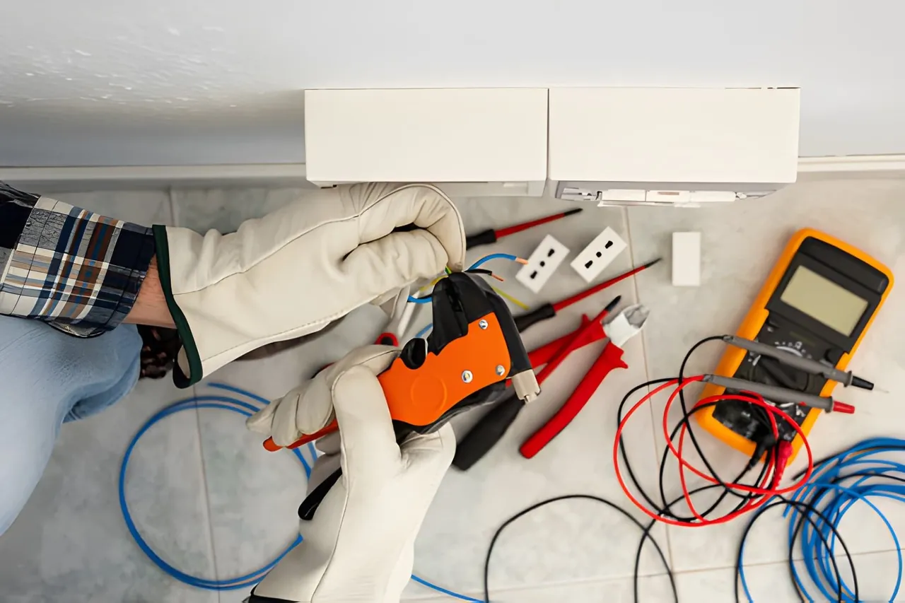 Electrician inspecting circuit breakers in a distribution board